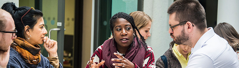 students having a discussion around a table